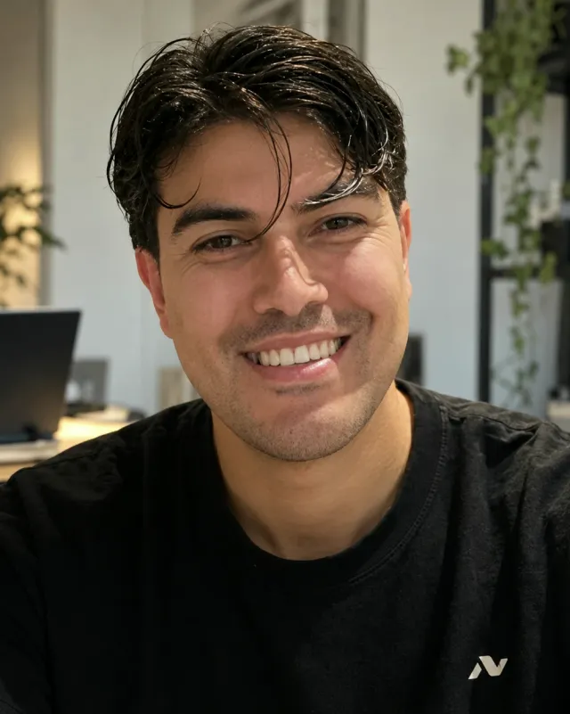 Fernando Valdez, smiling, at his desk at home